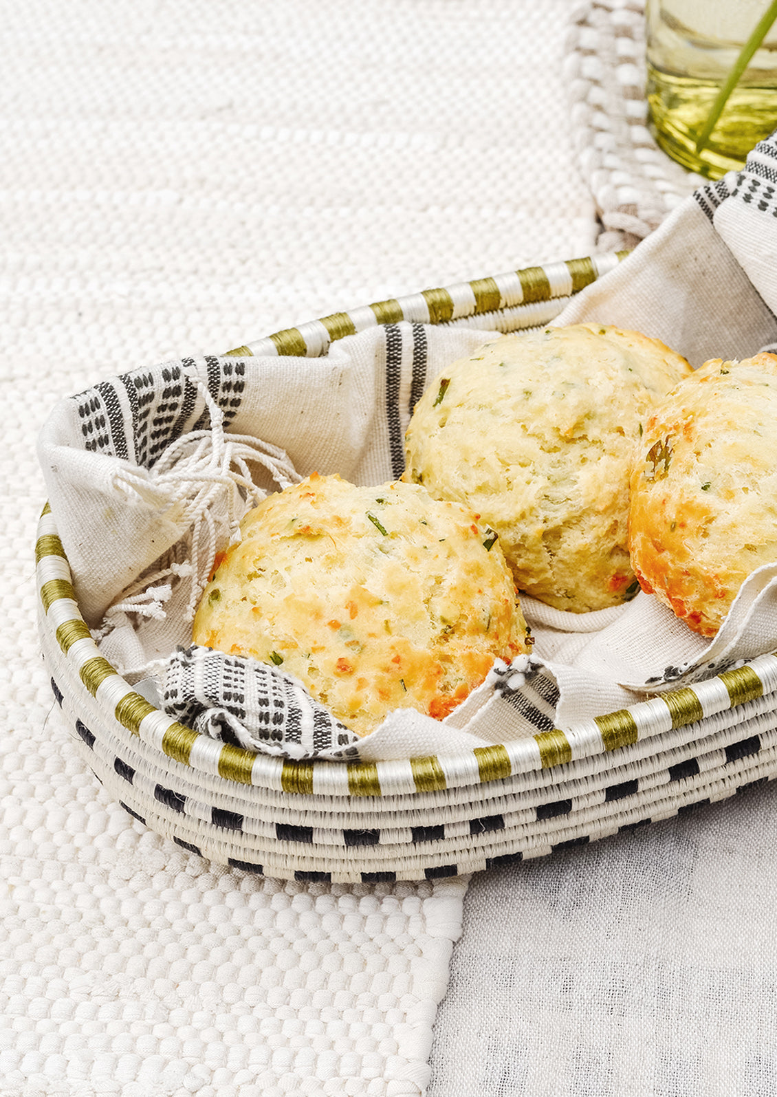 A woven bread basket holding scones.