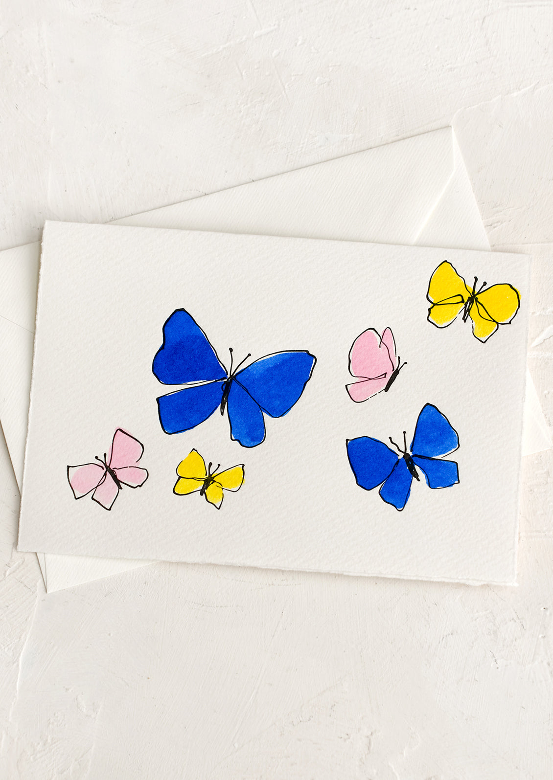 A card with blue, pink and yellow hand painted butterflies.