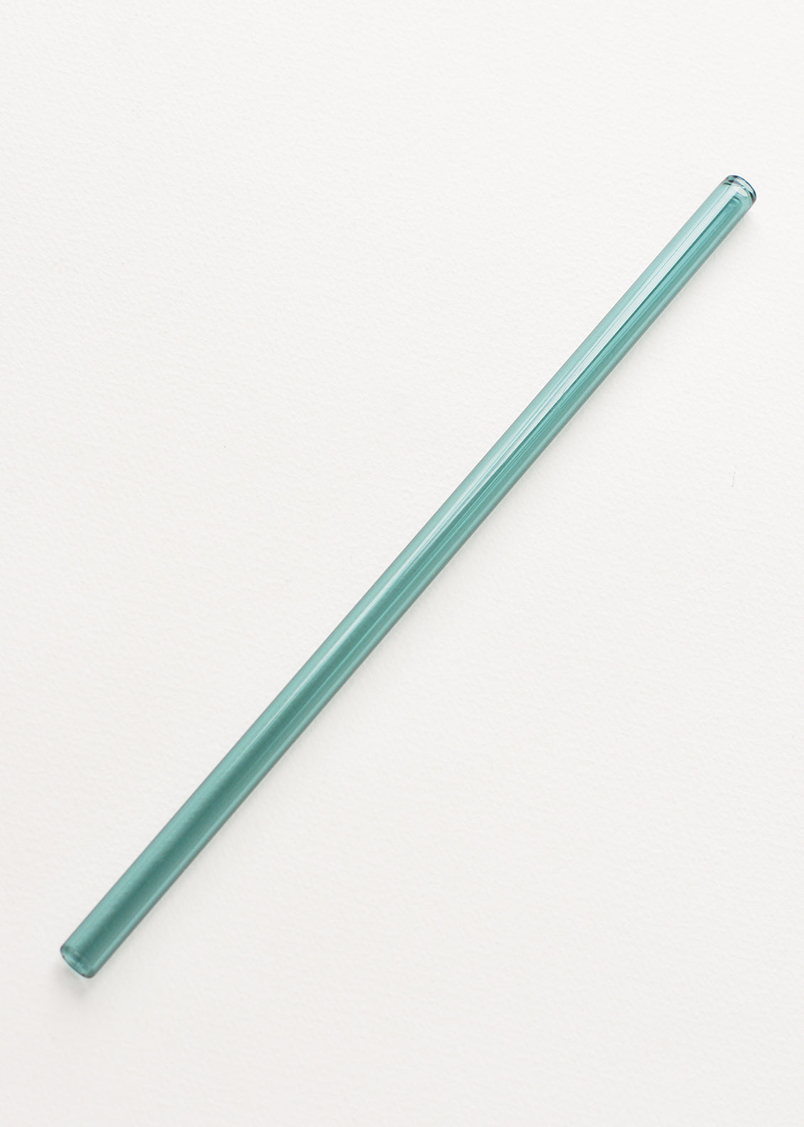 A sea green glass straw.