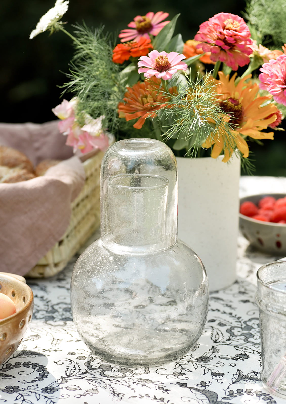 A set table with clear glass carafe.