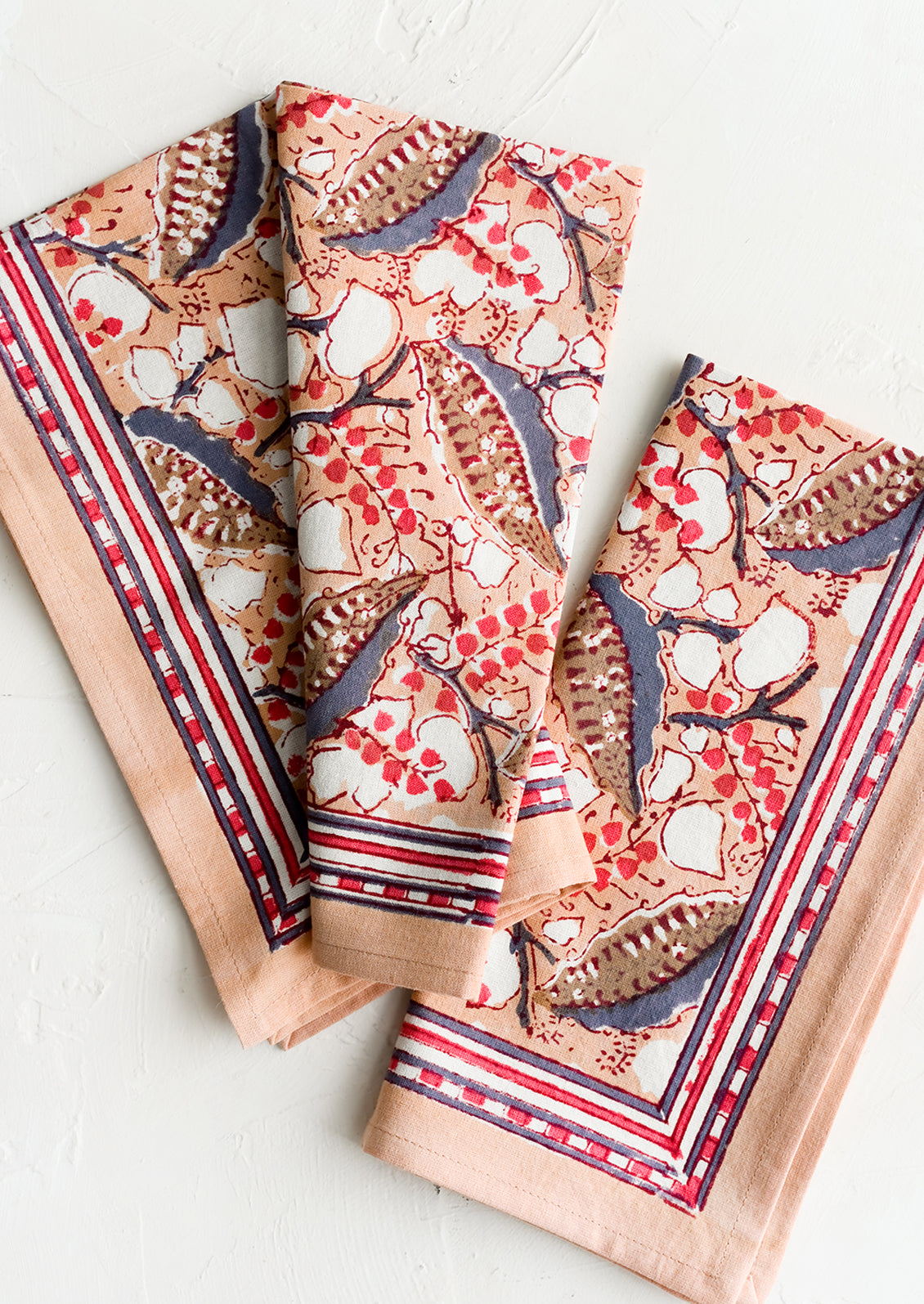 A pair of block printed napkins in seedpod botanical print.