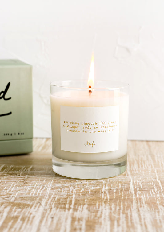 A jar candle with haiku print label.