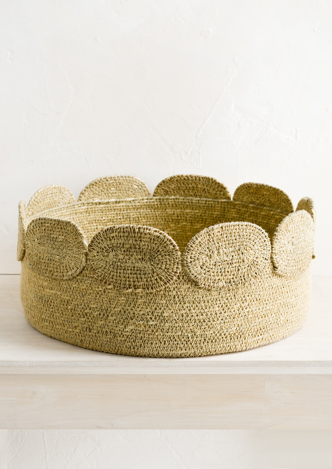 A shallow circular seagrass storage basket.