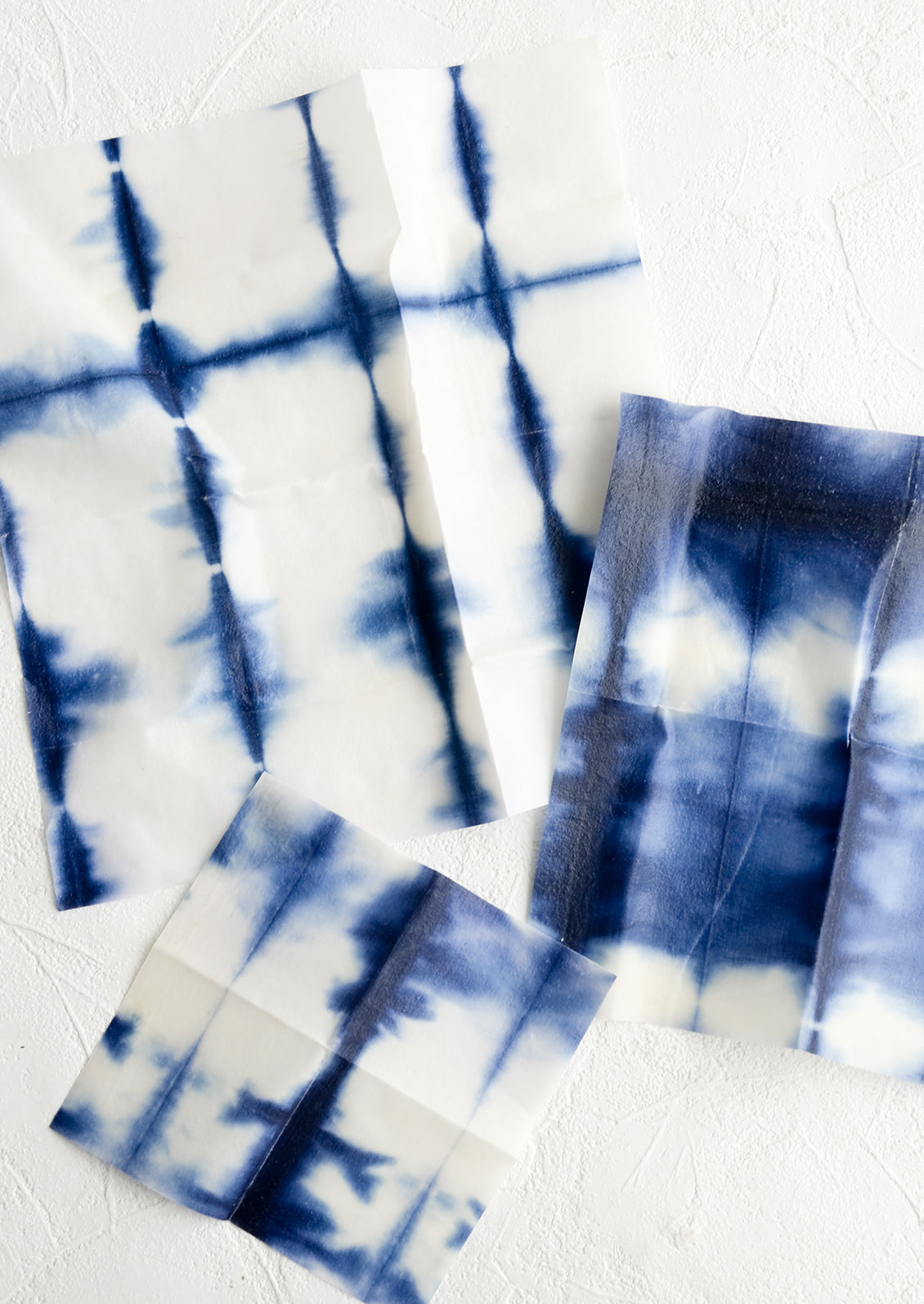 A set of three beeswax wraps with tie dye pattern in incremental sizes.