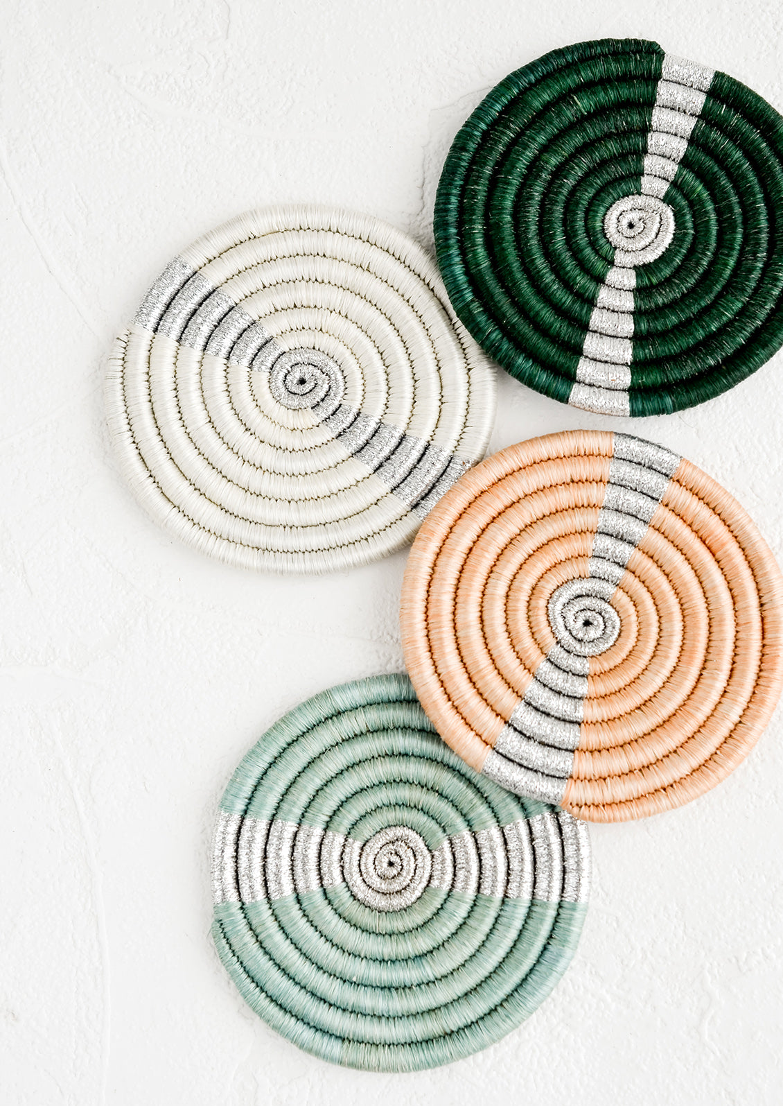 A set of coasters in different colors with silver streak across middle.