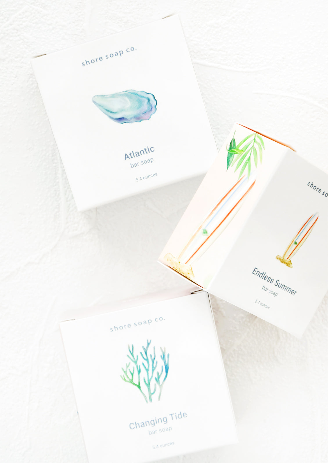 Square box packaging for bar soaps with nautical inspired designs