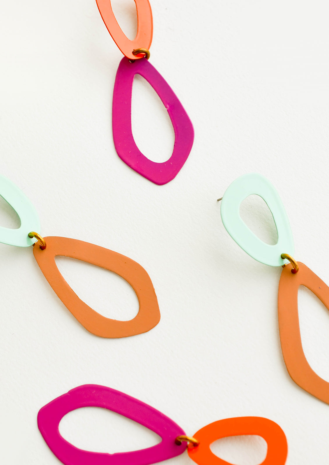 Two pairs of two toned figure eight earrings.