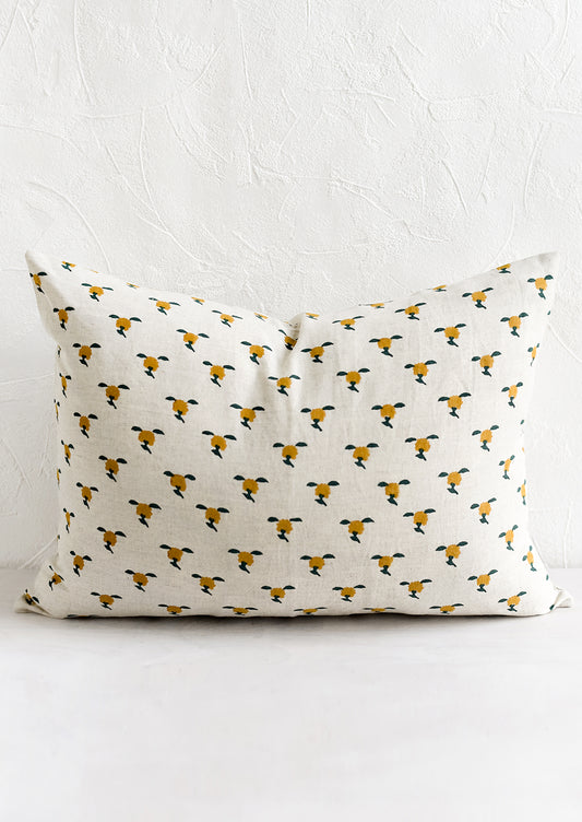 A block printed lumbar pillow with yellow and green floral motif.