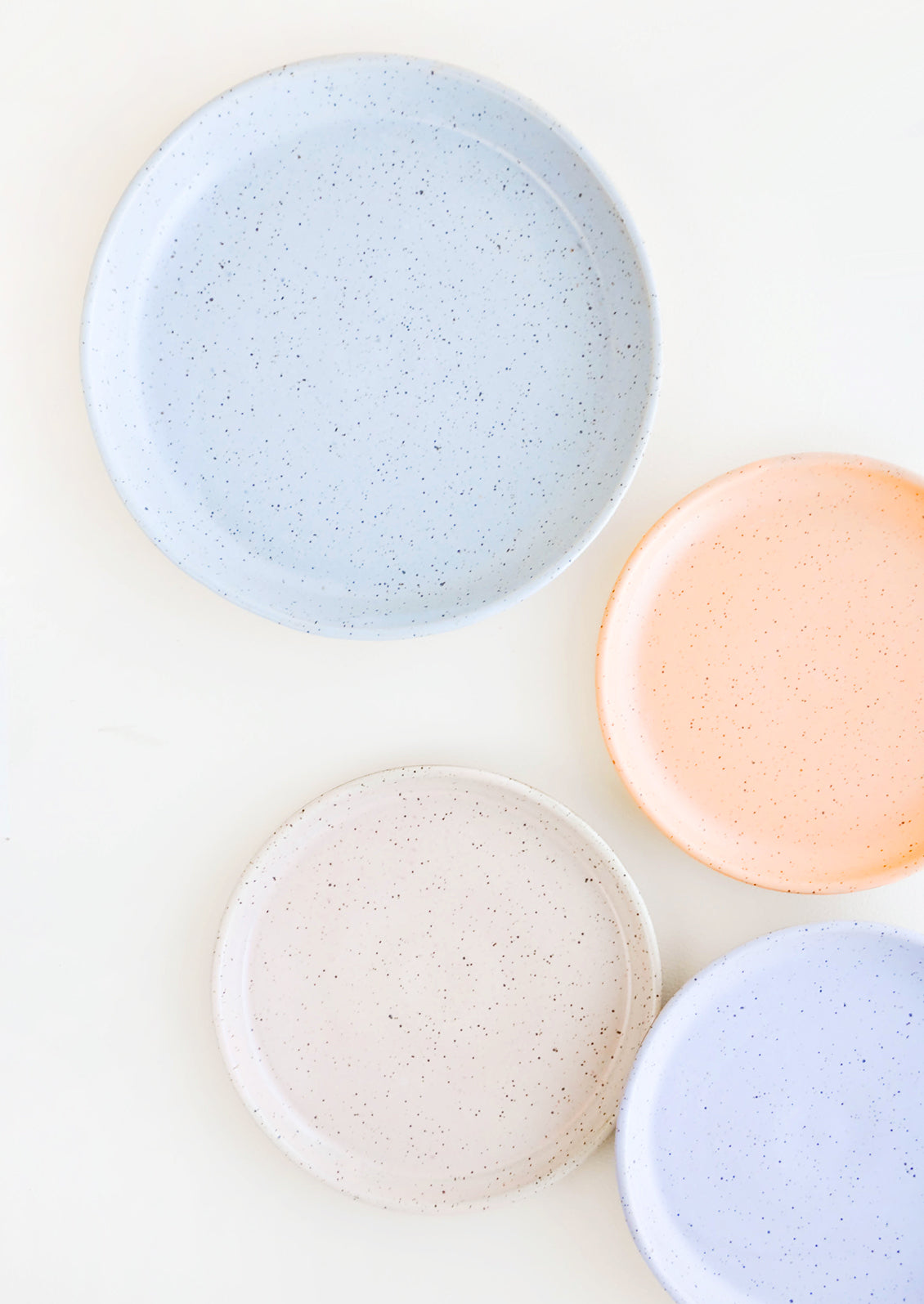 Four Speckled Ceramic Salad & Dinner Plates in blue, orange, pink and purple.