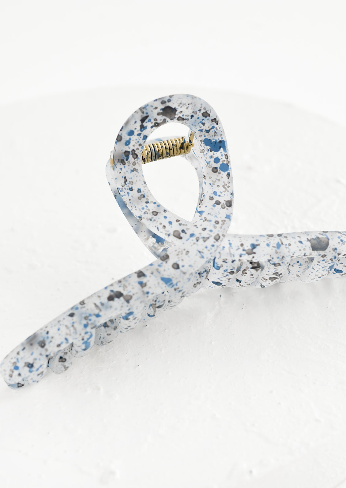 A french twist hair clip in speckled ink blue.