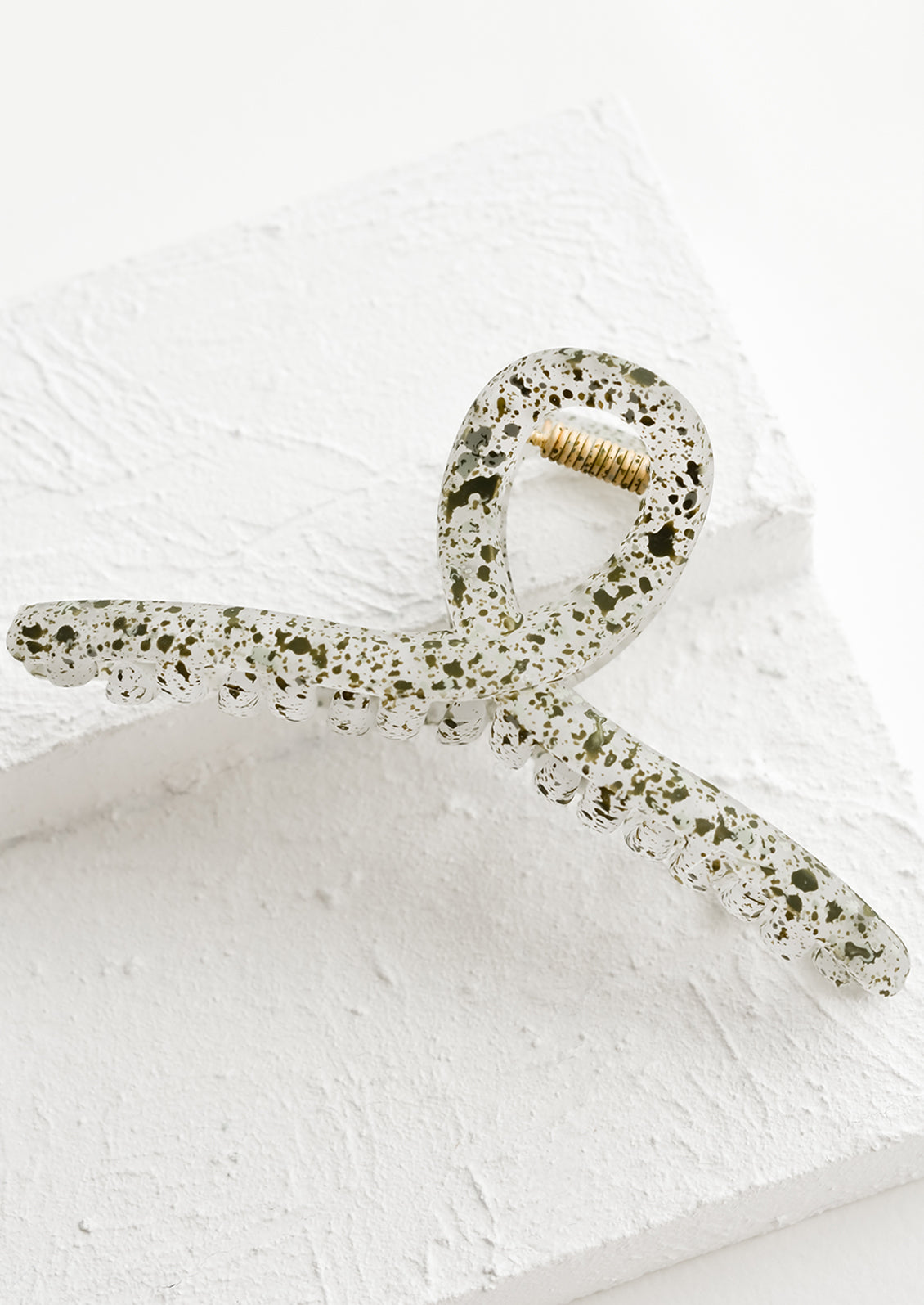 A french twist hair clip in speckled olive.