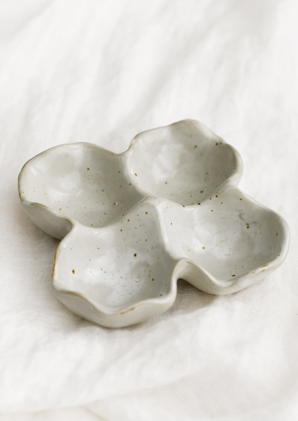 A ceramic egg holder designed to hold four eggs.