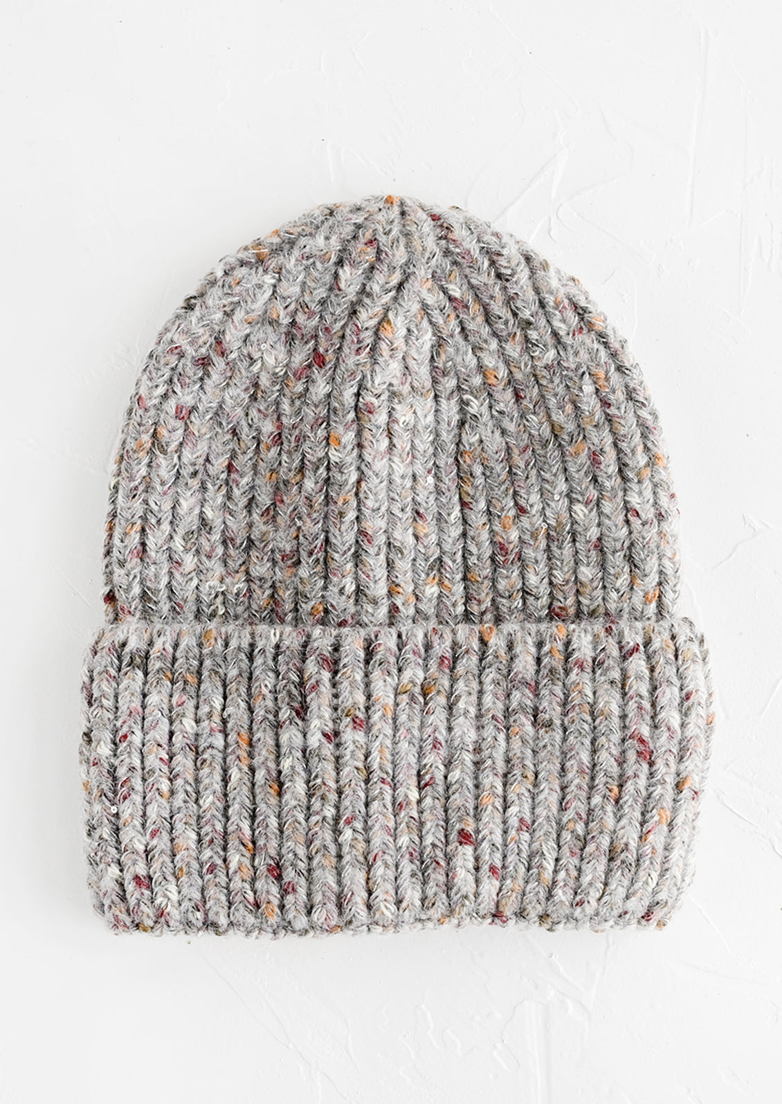 A knit beanie hat with cuffed rim made in speckled heather grey yarn.