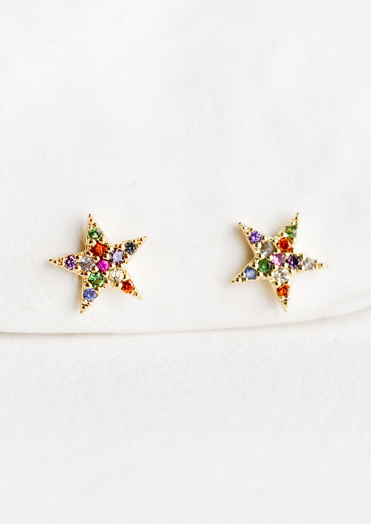 A pair of star shaped gold stud earrings with multicolor crystal pave.
