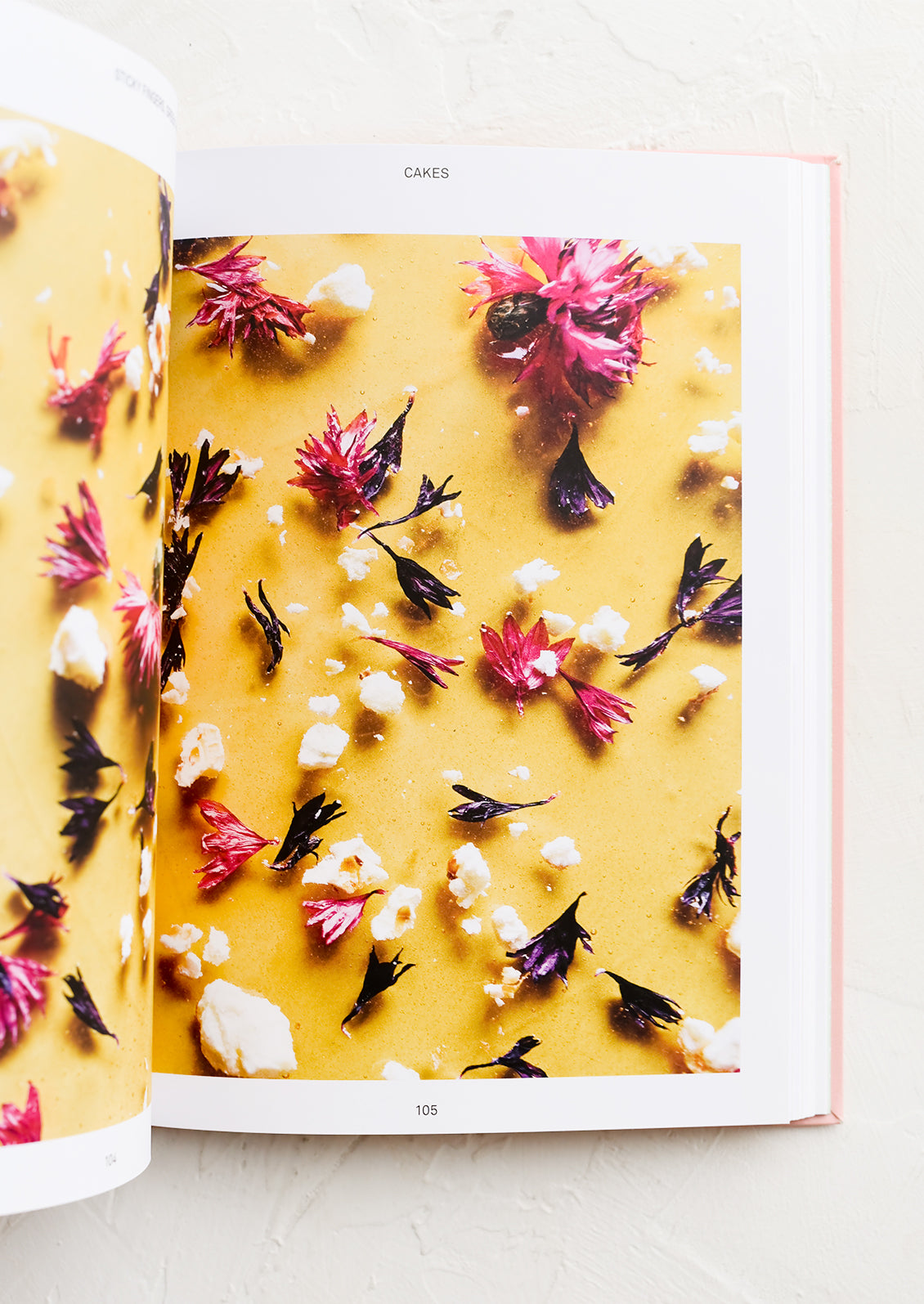 A cookbook open to image page of cake decoration.