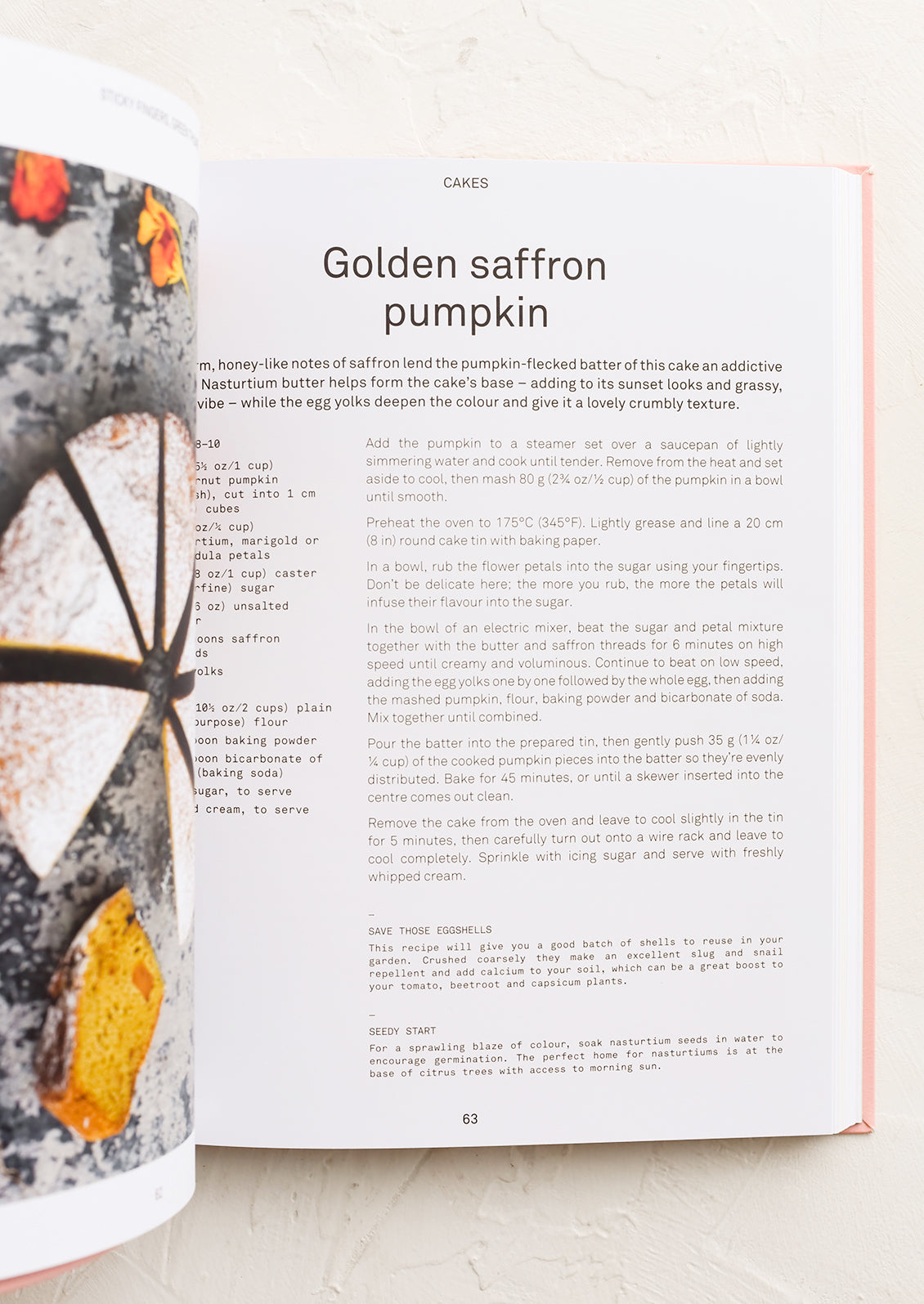 A cookbook open to a page with recipe for Golden saffron pumpkin cake.