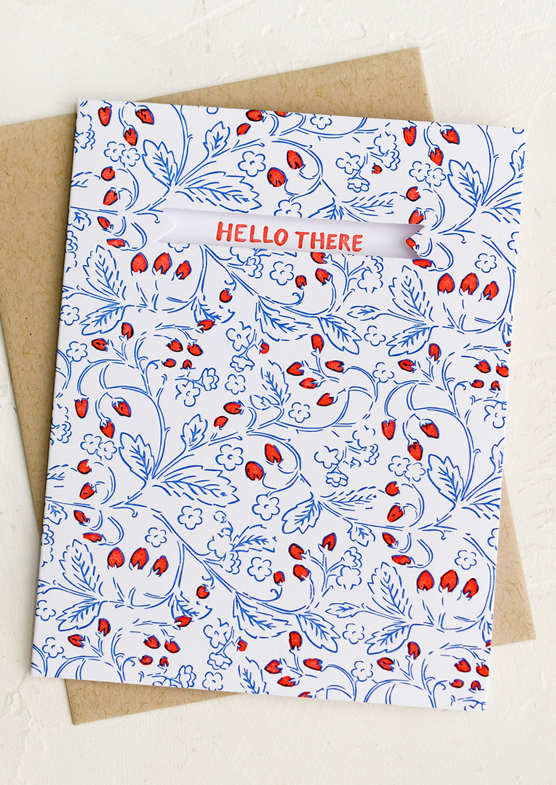 A card with blue and red strawberry print and text reading "Hello there".