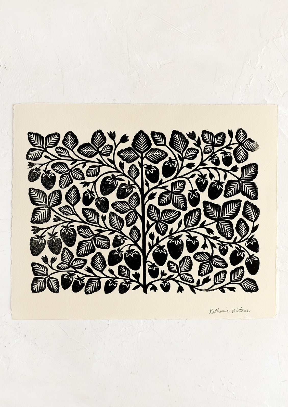 An ivory deckled edge paper with woodcut strawberry print in black ink.
