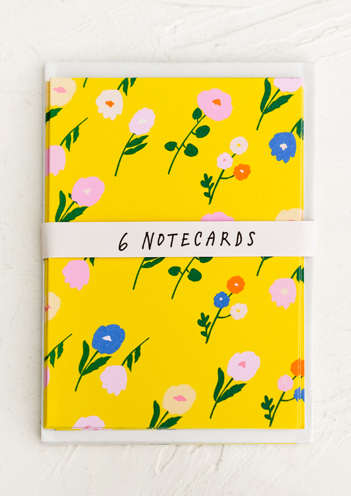 A set of yellow greeting cards with colorful floral print.