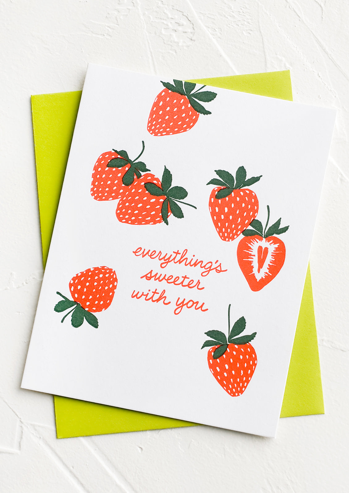 A strawberry printed greeting card reading "everything's sweeter with you".