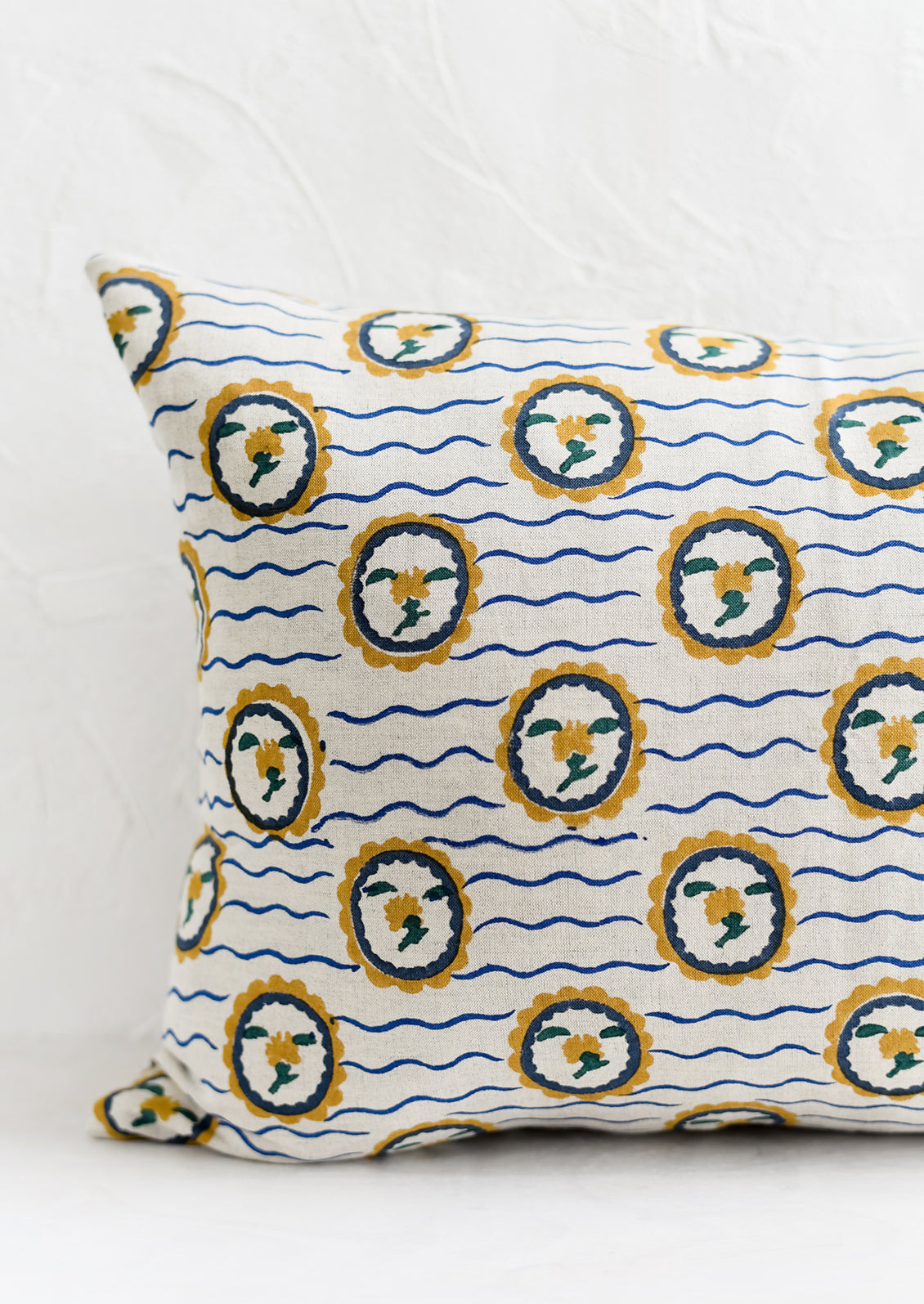 A block printed pillow with wavy floral motif.