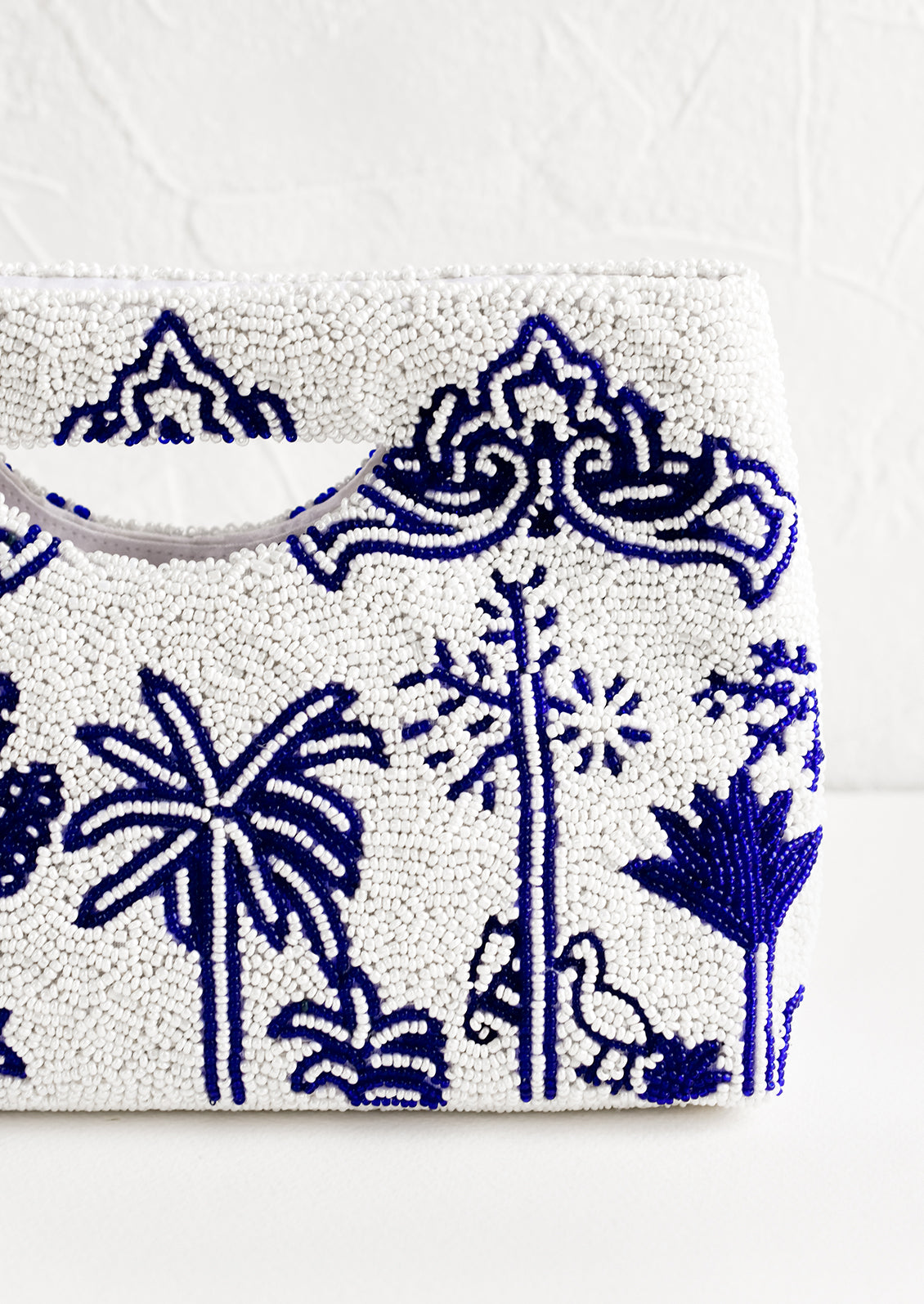 A white and blue beaded clutch.