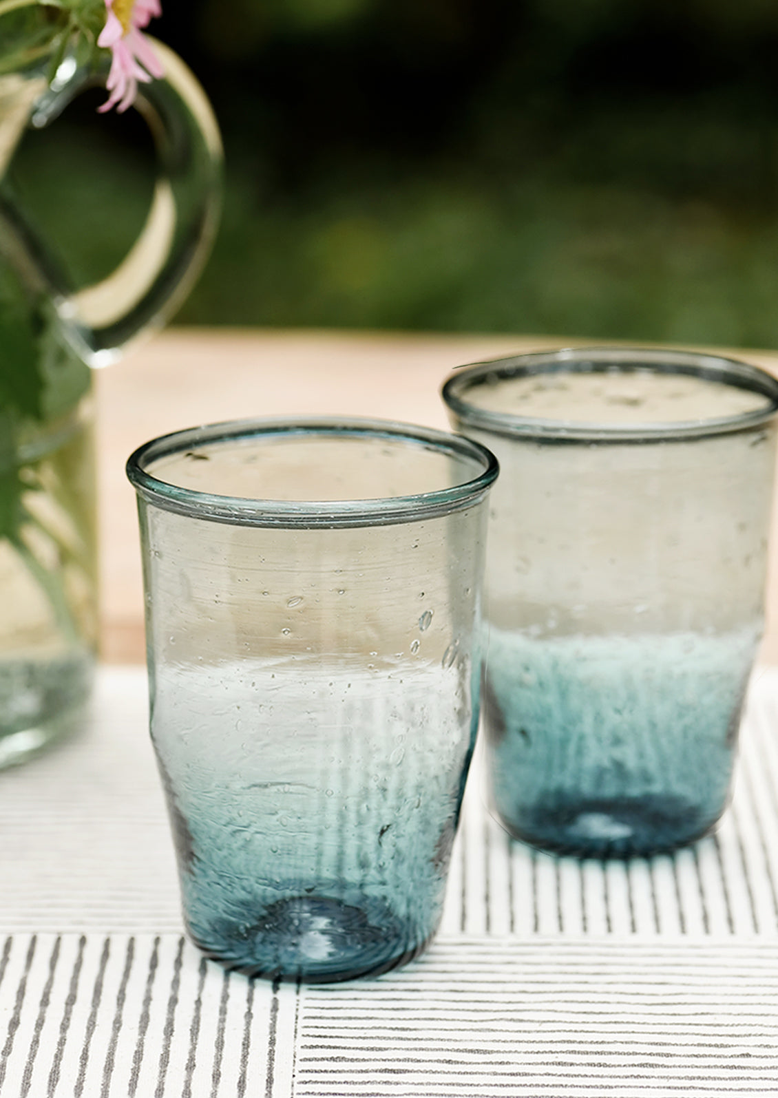 Two glass tumblers in tapered silhouettte.