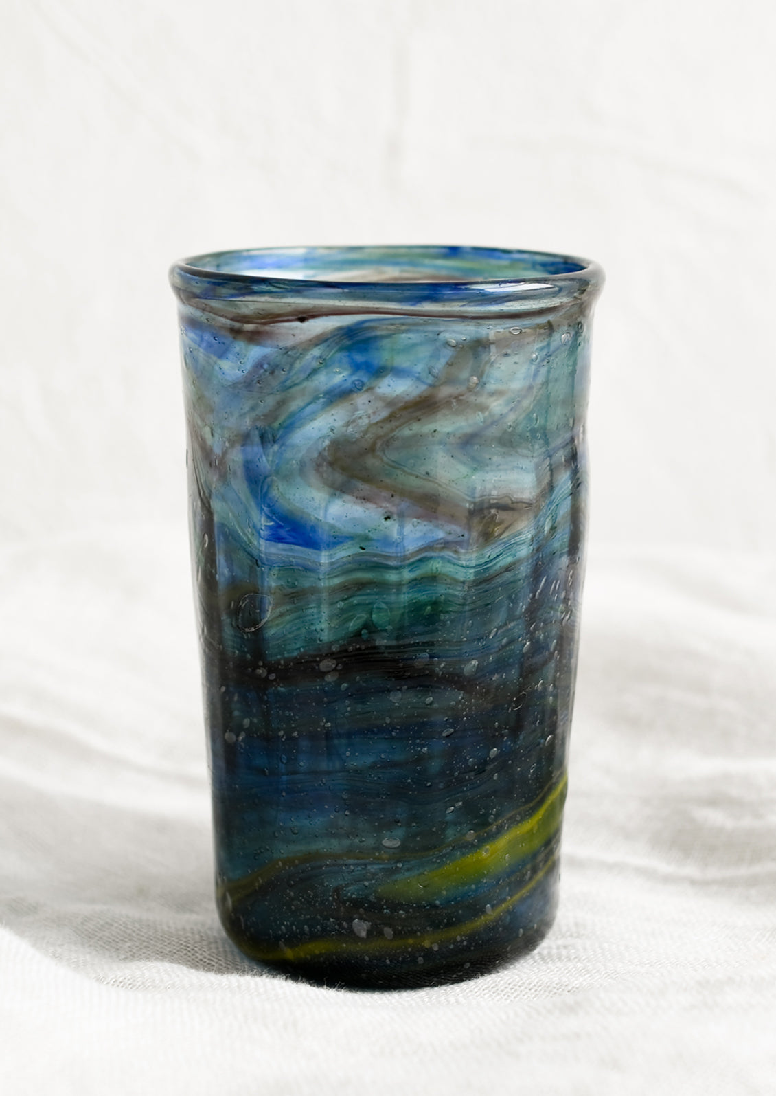 A glass tumbler in marine blue color.
