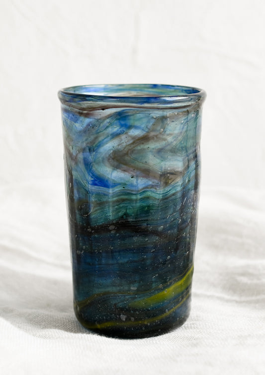 A glass tumbler in marine blue color.
