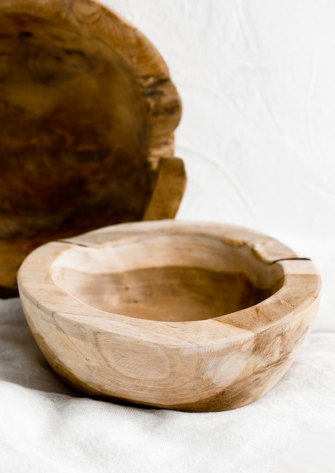 Natural teakwood bowls in variations of light and dark.