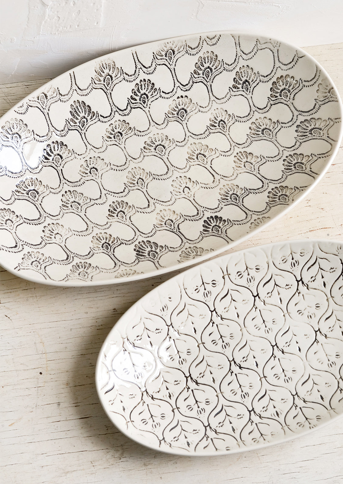 Oval shaped ceramic platters with black and white textile pattern.