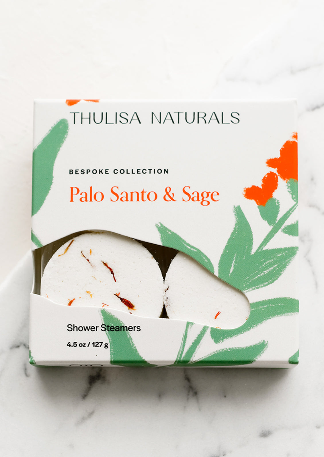 A box of shower steamer tablets in palo santo & sage scent.