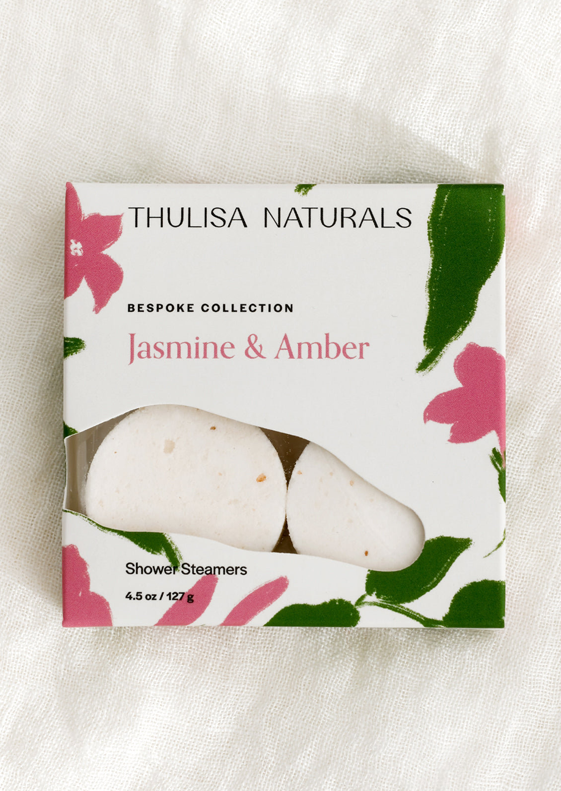 A box of shower steamer tablets in jasmine & amber scent.