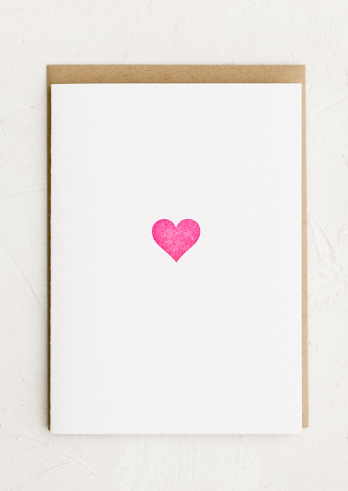 A plain white card with pink heart.
