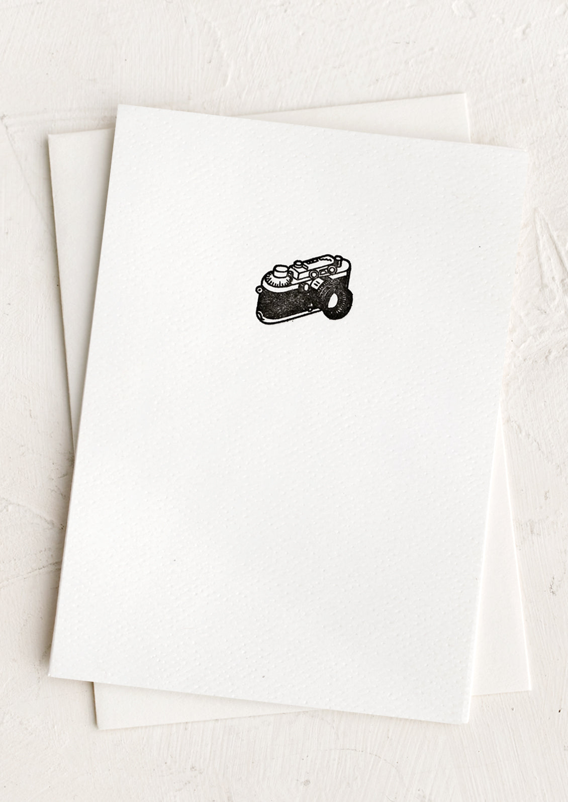 A plain white card with small camera icon at front.