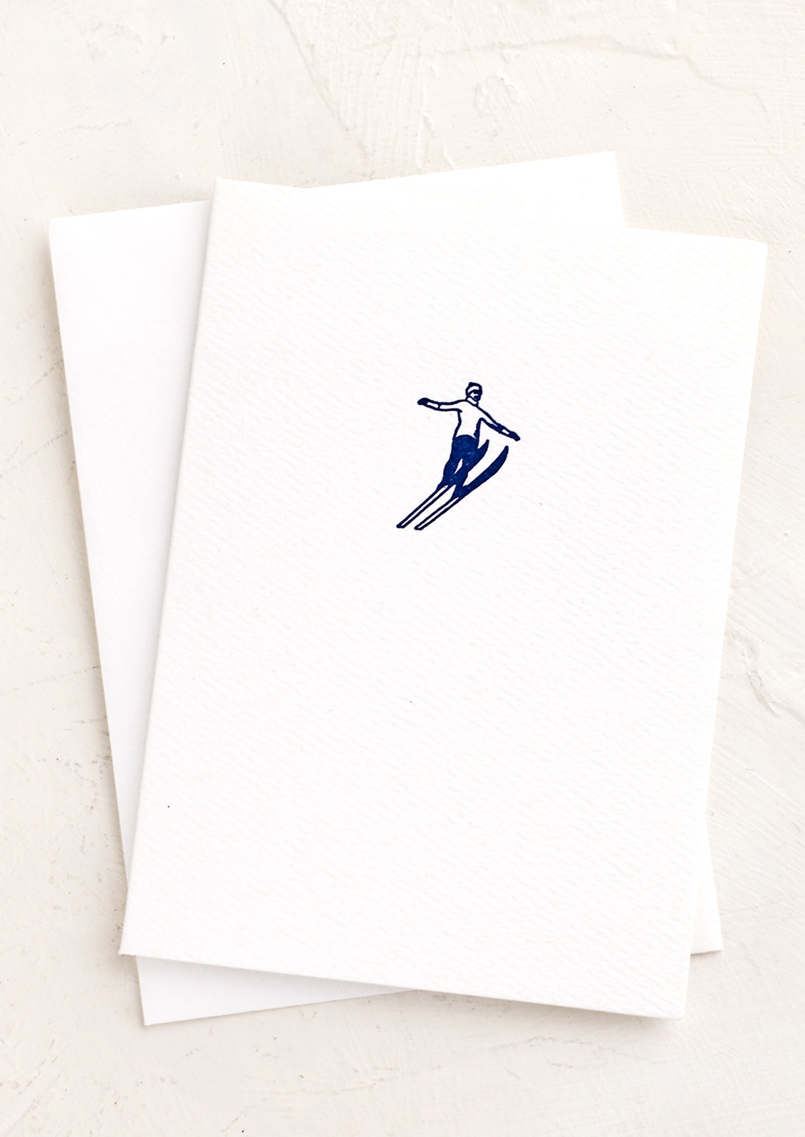 A white card with a blue skier icon.