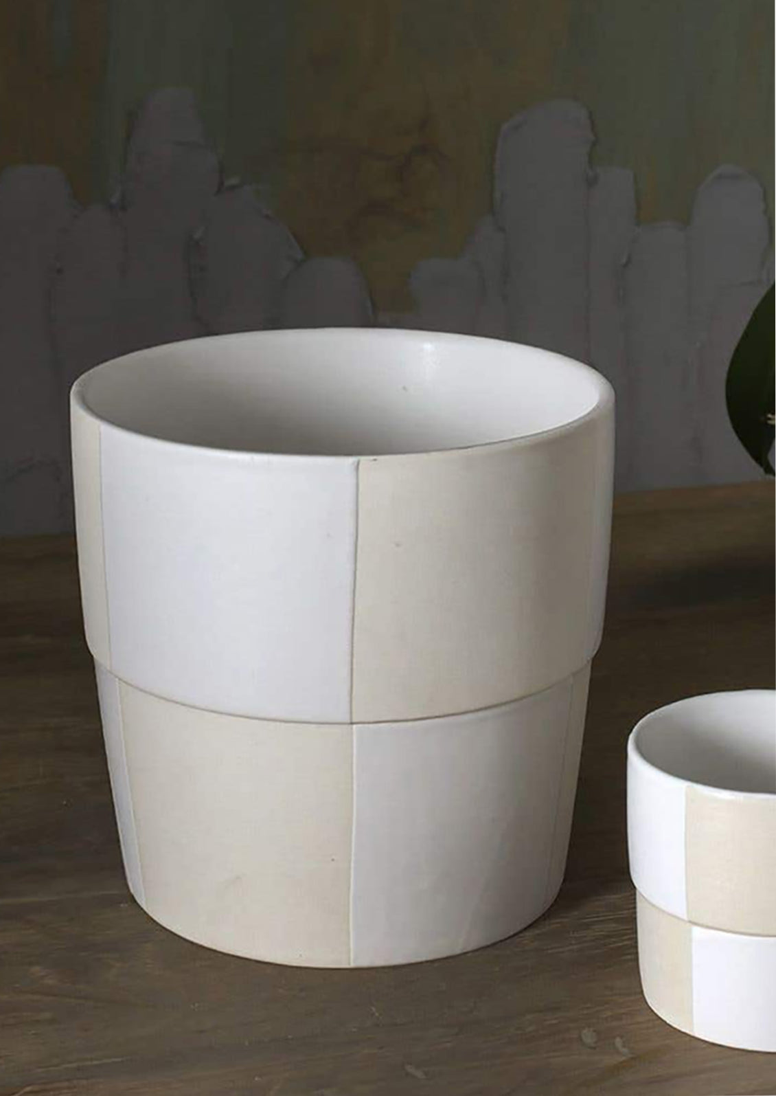 A cream and white checker patterned planter pot.