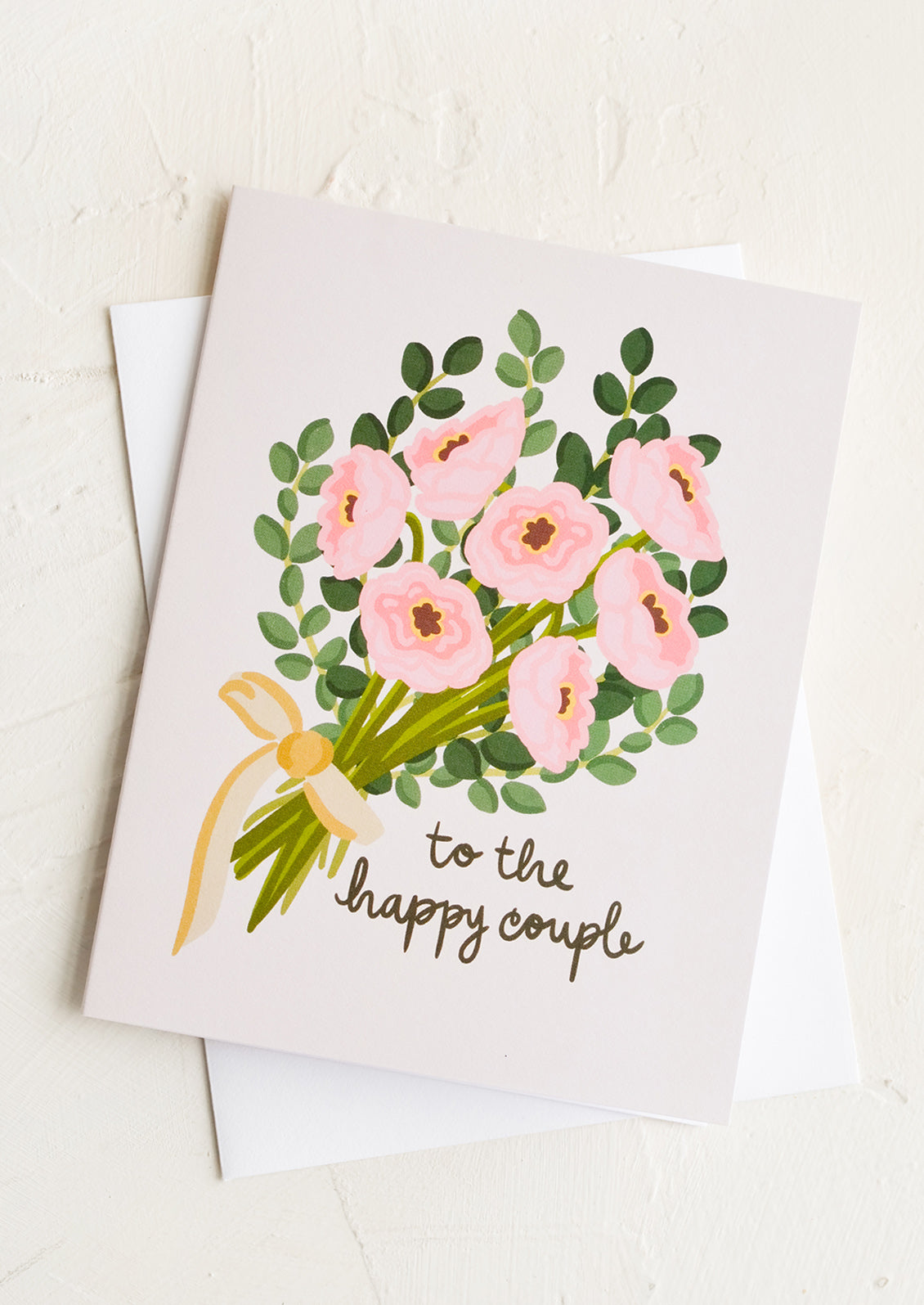 A greeting card with bouquet and text reading "to the happy couple".