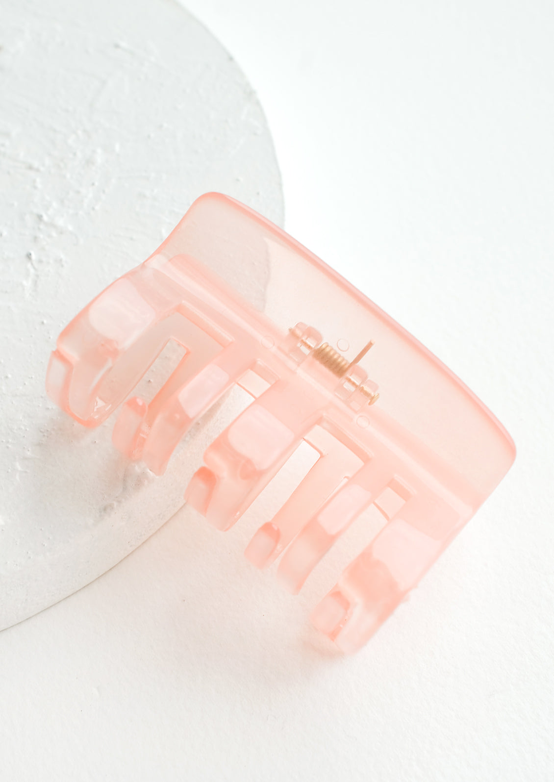 A transparent hair clip in light pink.