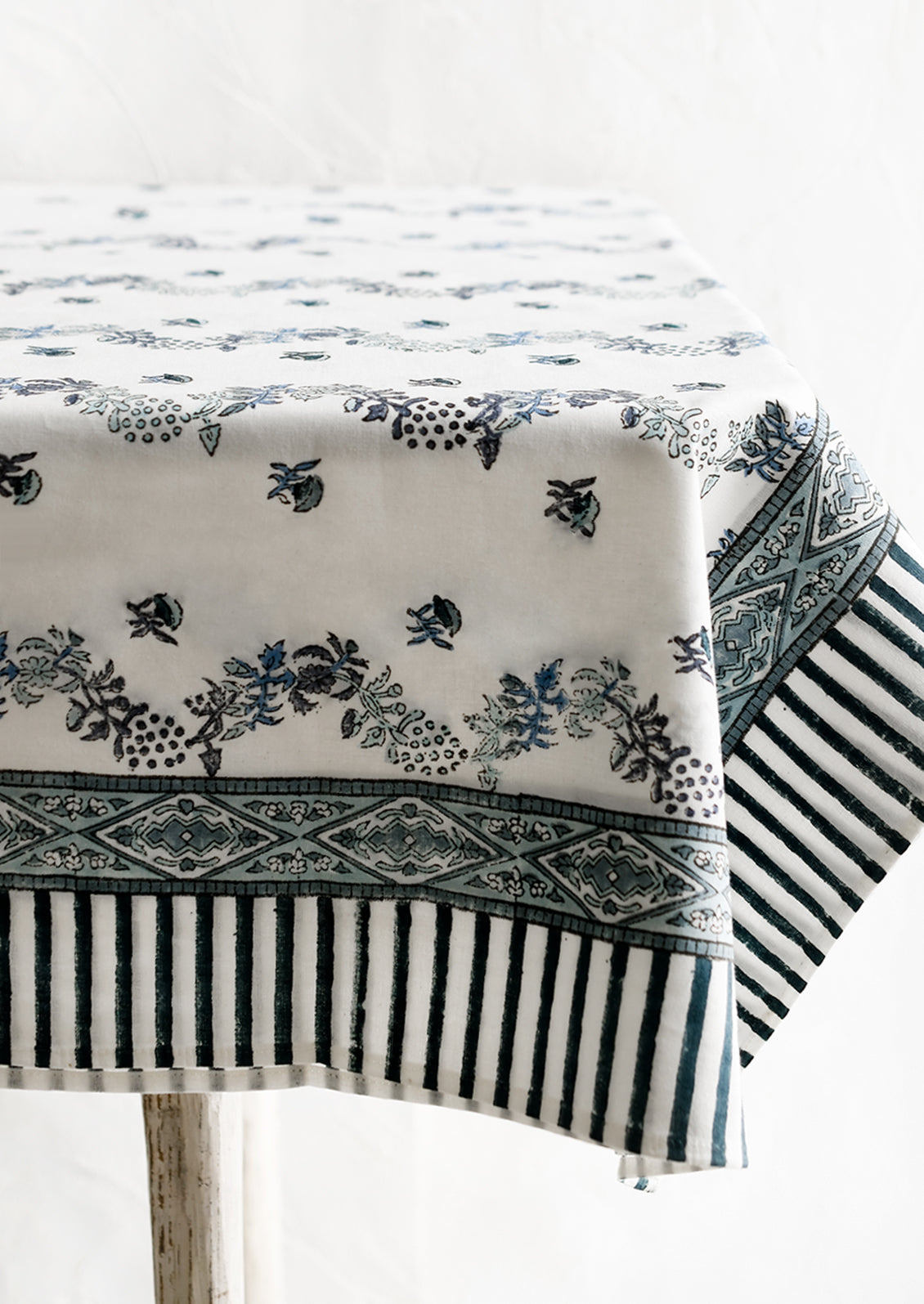 A block printed floral tablecloth in white and blue.