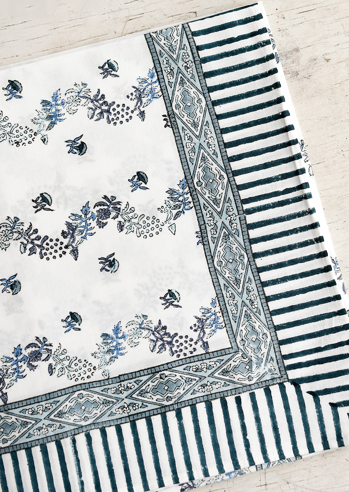 A block printed floral tablecloth in white and blue.