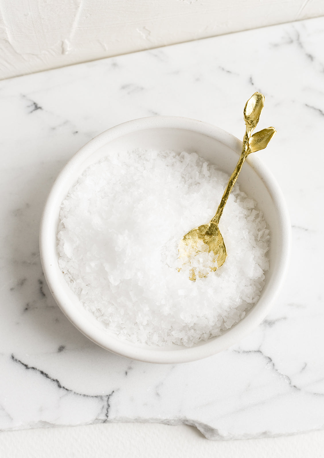 A brass spoon in salt cellar.