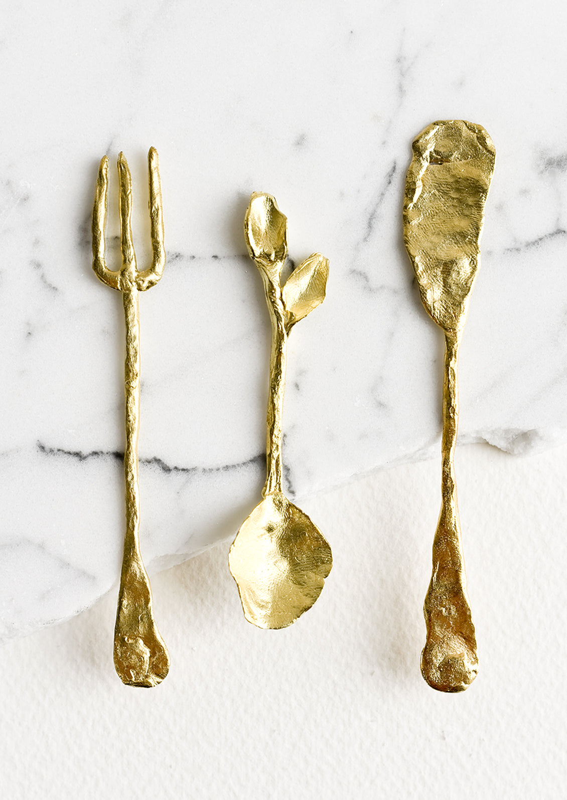 Small brass fork, spoon and knife.
