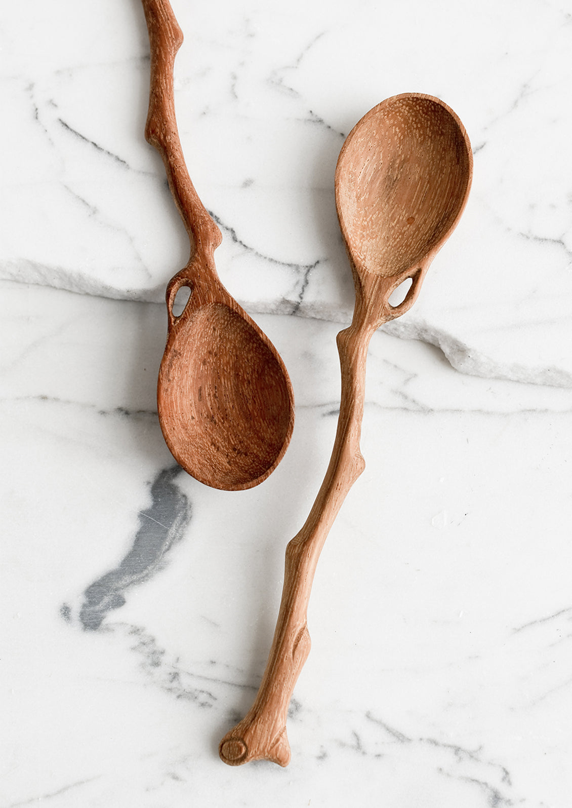 A wooden spoon in shape of tree branch.