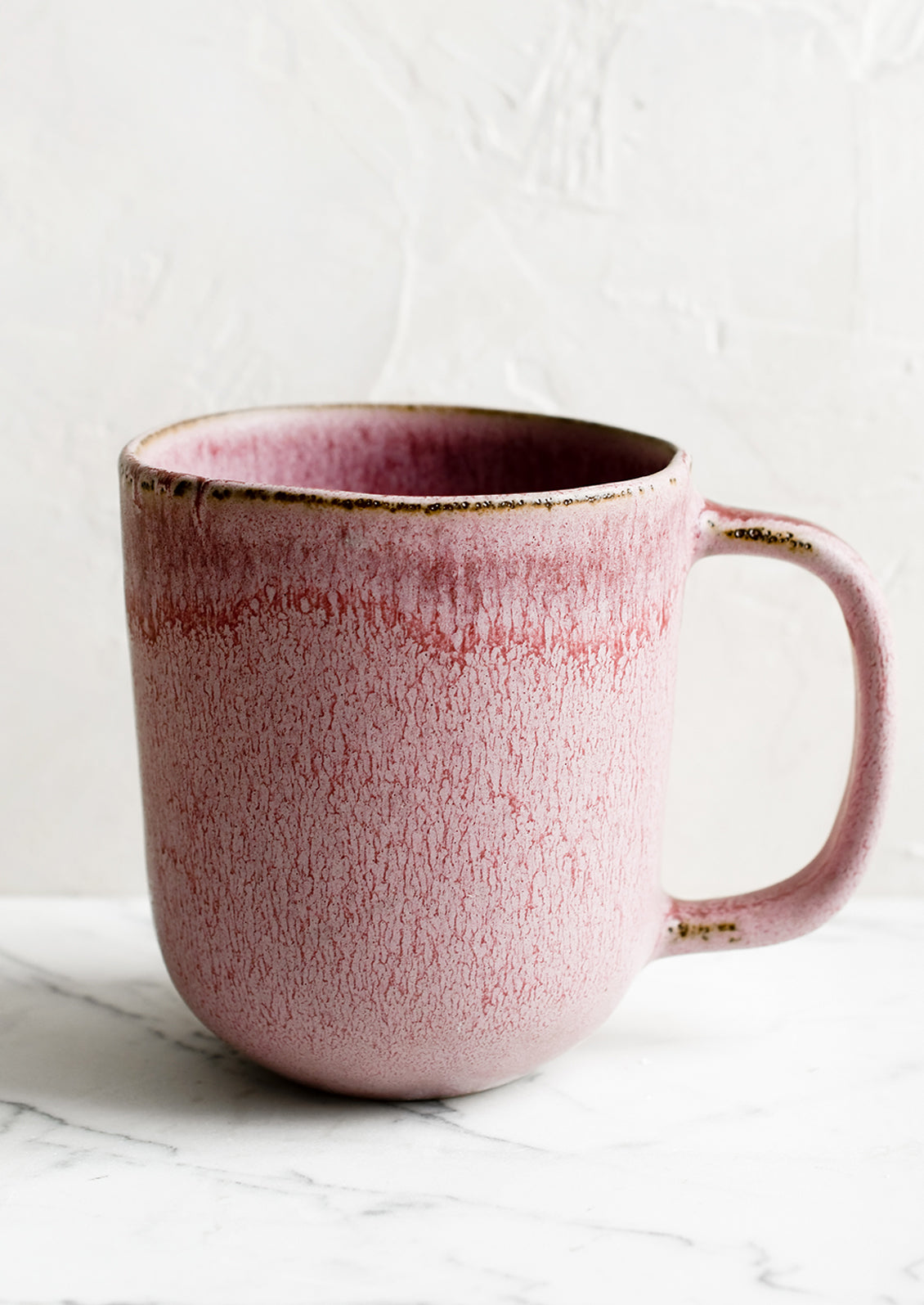A purple ceramic mug with mottled glaze appearance.