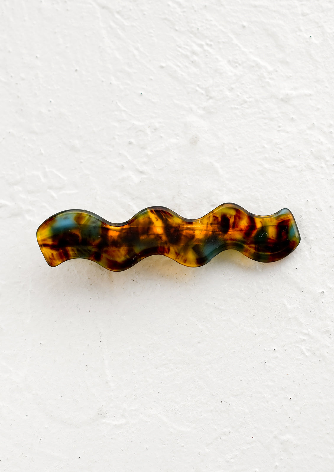 A wavy hair barrette in tortoiseshell.