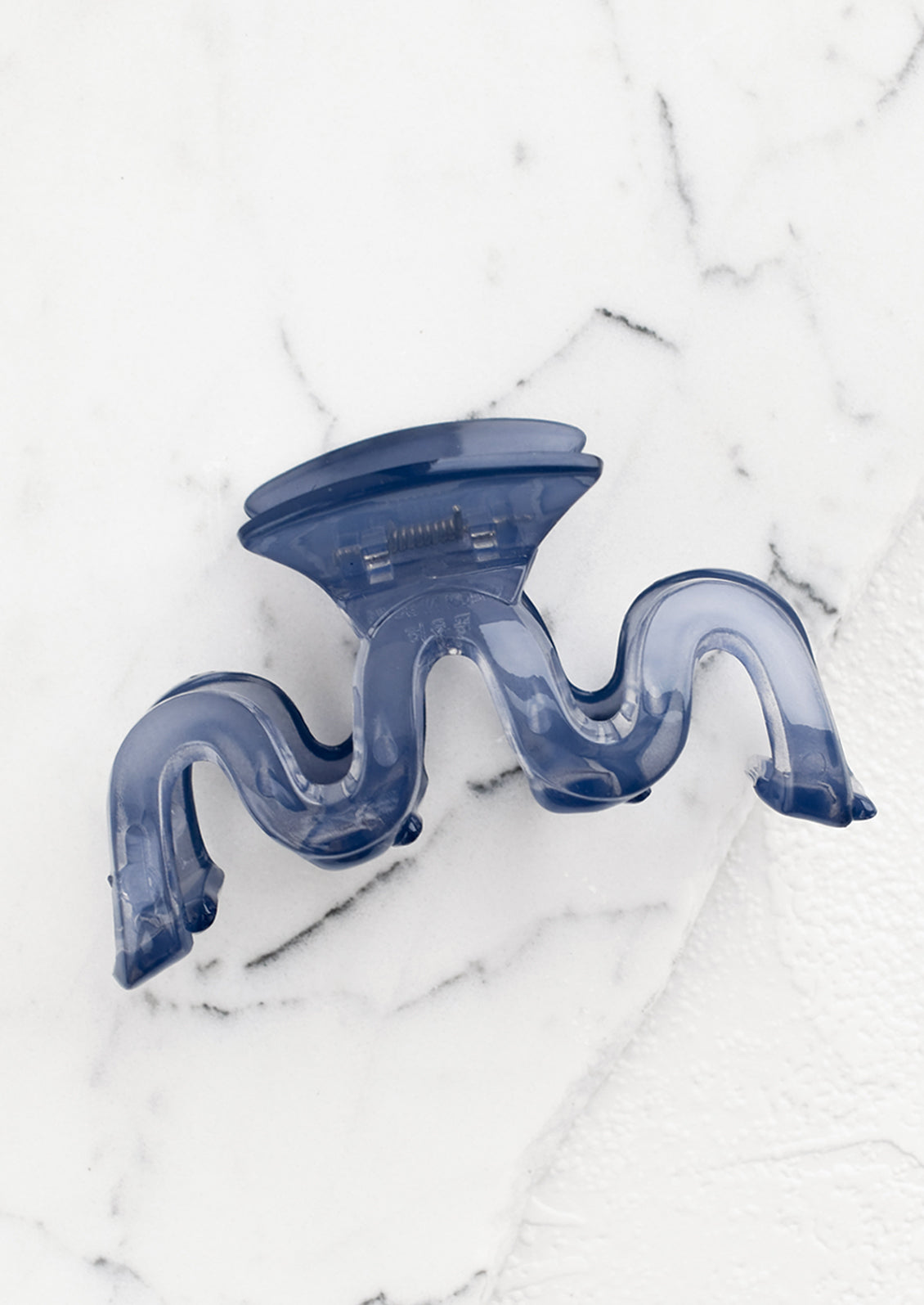 A wavy squiggle hair claw in storm blue.