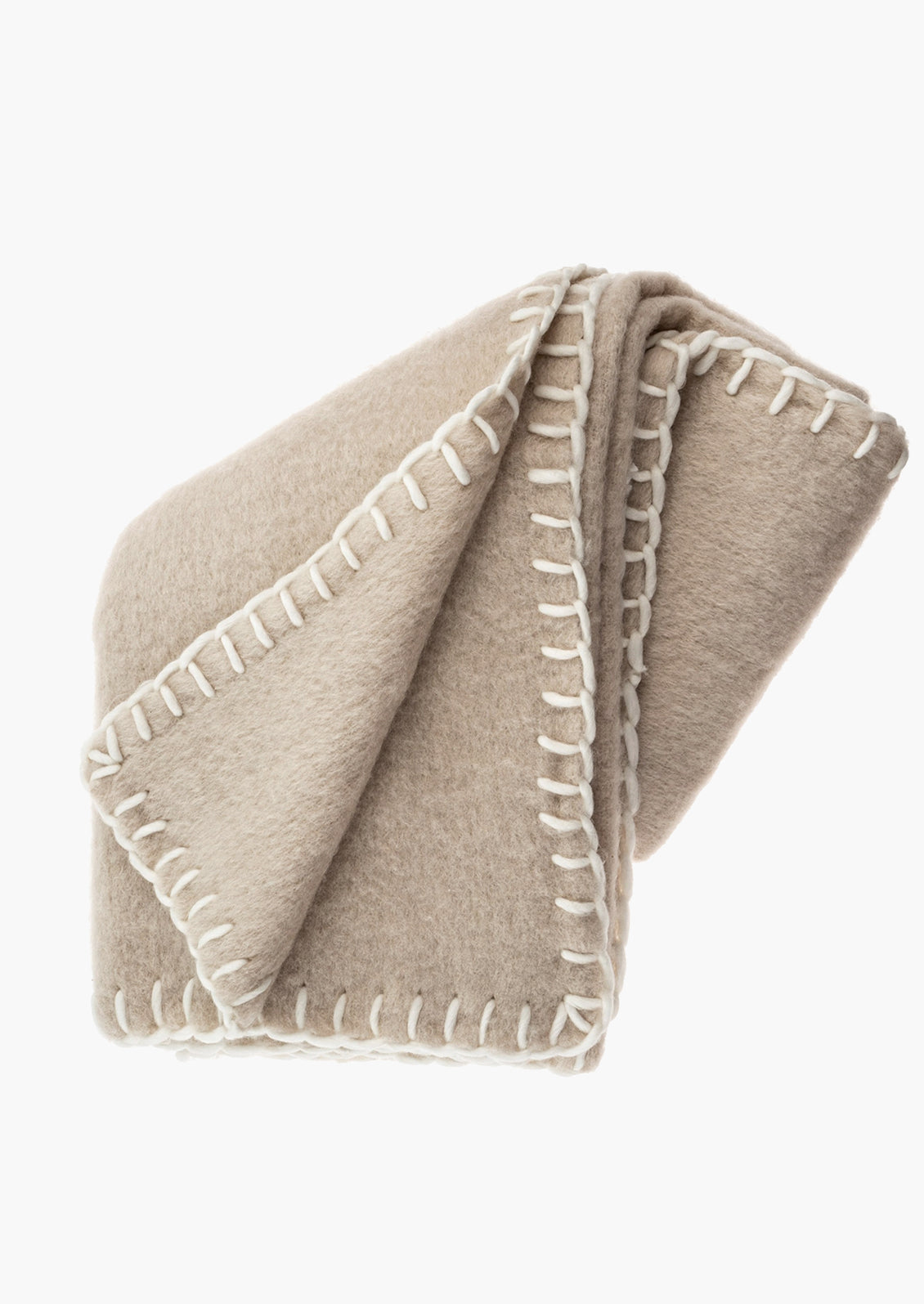 A beige mohair blanket with white yarn whipstitched trim.