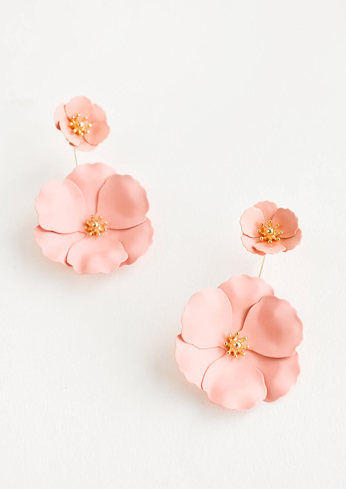 Two part pale pink and gold flower earrings with a small flower post and larger flower drop. 