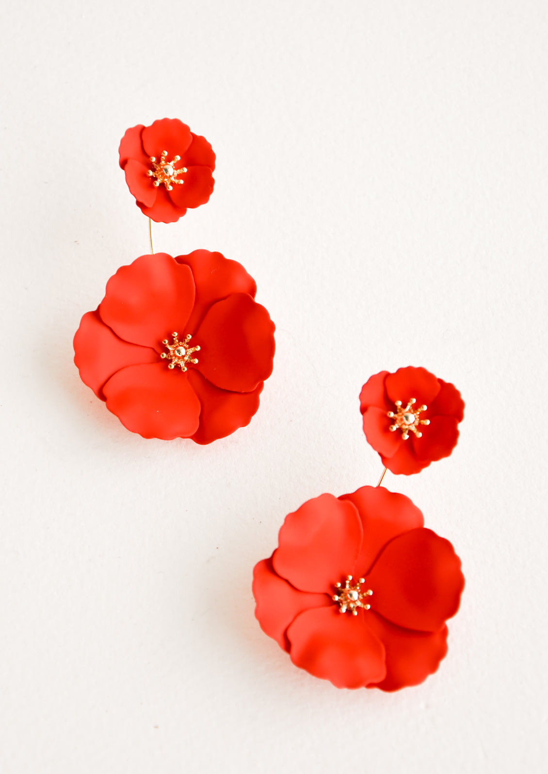 Two part poppy red and gold flower earrings with a small flower post and larger flower drop. 